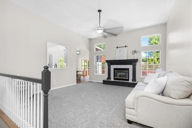 709 SW Graystone Dr, Grain Valley, MO 64029 - living area with a ceiling fan, carpet floors, and a tile fireplace