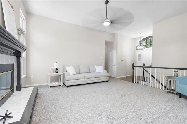 709 SW Graystone Dr, Grain Valley, MO 64029 - carpeted living room with ceiling fan and a tile fireplace