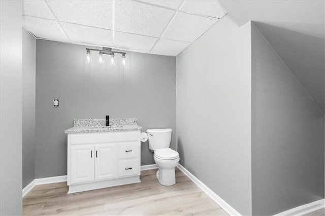 709 SW Graystone Dr, Grain Valley, MO 64029 - bathroom featuring wood finished floors, vanity, and a drop ceiling