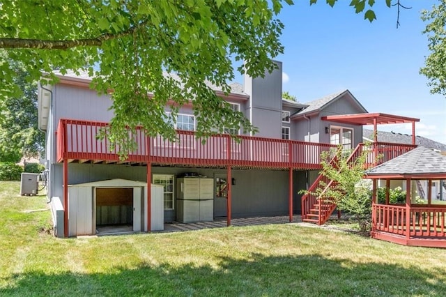 709 SW Graystone Dr, Grain Valley, MO 64029 - back of property with a wooden deck, a yard, and stairs