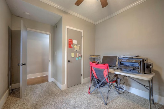 carpeted home office with baseboards, ornamental molding, and a ceiling fan