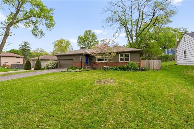 single story home with brick siding, an attached garage, a front yard, and aphalt driveway