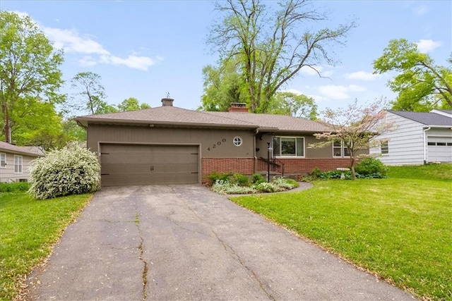 ranch-style home with a garage, a front yard, a chimney, brick siding, and driveway