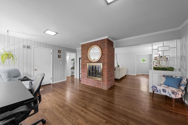 office with crown molding, a fireplace, wood finished floors, and visible vents
