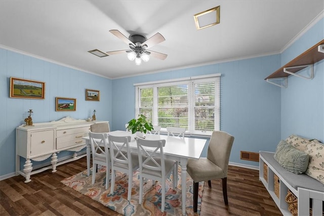 dining room with crown molding, ceiling fan, dark wood finished floors, and visible vents