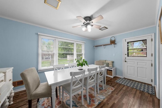 dining room with crown molding, baseboards, ceiling fan, and dark wood-style floors