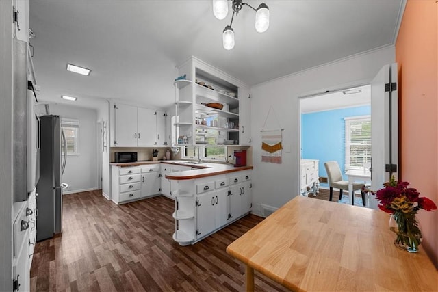 kitchen featuring open shelves, black microwave, freestanding refrigerator, white cabinetry, and dark wood-style floors
