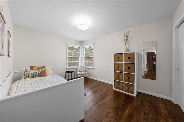 bedroom with baseboards and wood finished floors