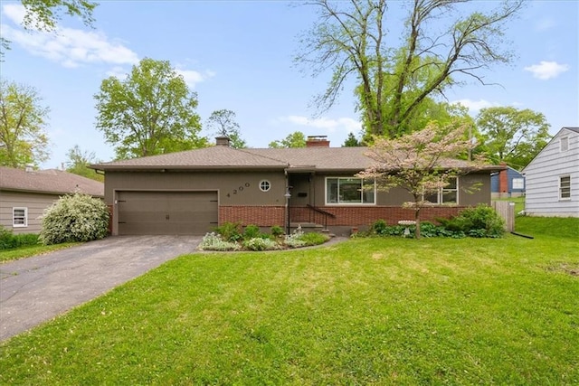 ranch-style house featuring aphalt driveway, a chimney, brick siding, a front lawn, and an attached garage