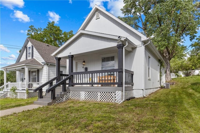 69 N Valley St, Kansas City, KS 66102 - view of front of house with covered porch, a front yard, and central AC unit