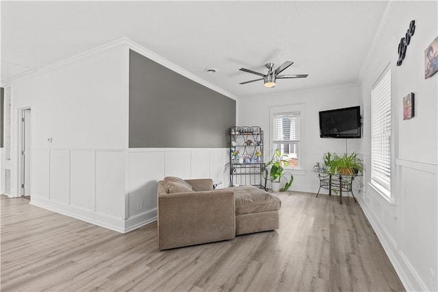 69 N Valley St, Kansas City, KS 66102 - living area featuring wood finished floors, ceiling fan, a decorative wall, ornamental molding, and a wainscoted wall