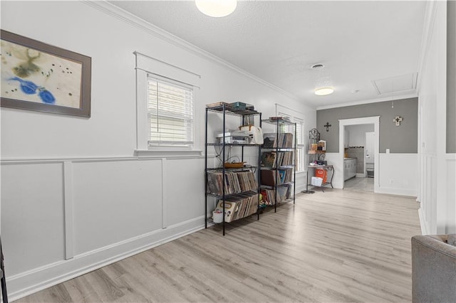 69 N Valley St, Kansas City, KS 66102 - hallway featuring attic access, a decorative wall, ornamental molding, wood finished floors, and a textured ceiling