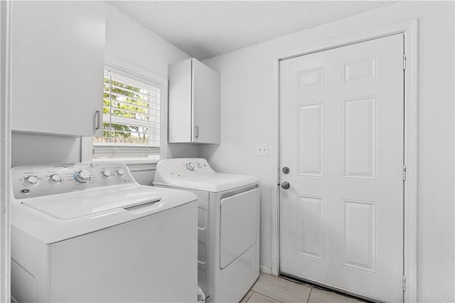 69 N Valley St, Kansas City, KS 66102 - clothes washing area with washing machine and dryer, cabinet space, and light tile patterned flooring