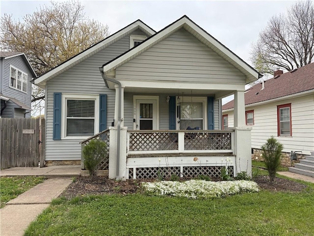 1450 Central St, Leavenworth, KS 66048 - bungalow-style house with fence, covered porch, and a front lawn