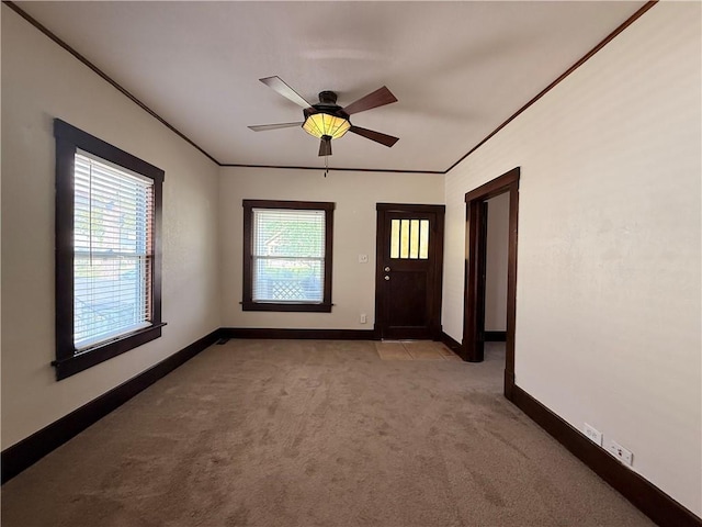 1450 Central St, Leavenworth, KS 66048 - empty room with crown molding, baseboards, ceiling fan, and light colored carpet