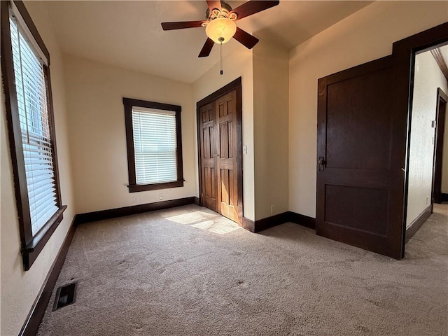 1450 Central St, Leavenworth, KS 66048 - unfurnished bedroom with light colored carpet, baseboards, visible vents, and multiple windows