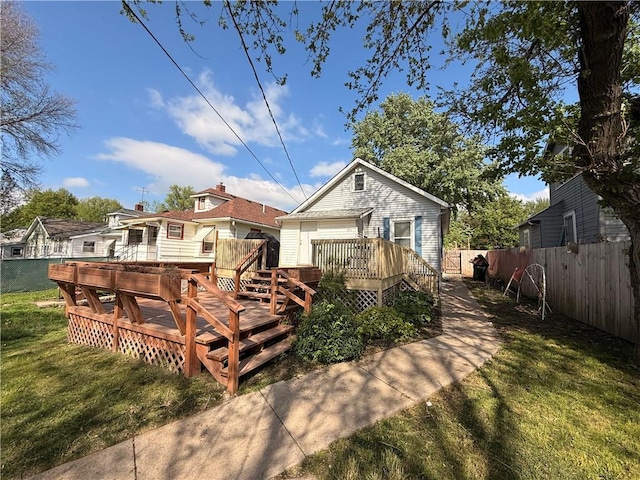 1450 Central St, Leavenworth, KS 66048 - back of property with a lawn, a deck, and a fenced backyard