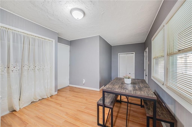 501 N Westwood Dr, Independence, MO 64050 - dining area with light wood-style floors, baseboards, and a textured ceiling