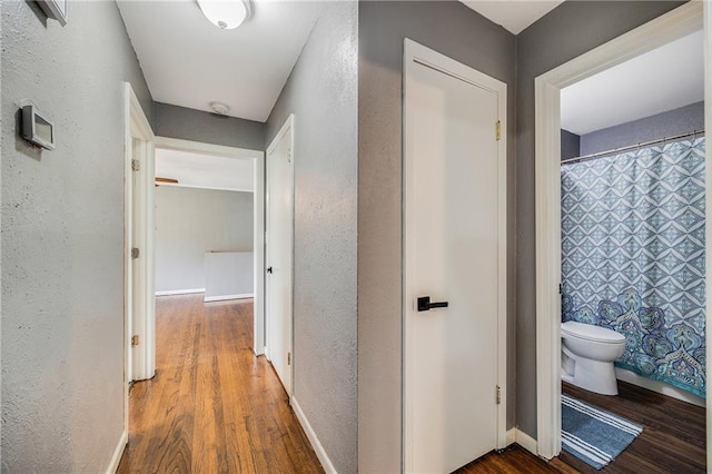 501 N Westwood Dr, Independence, MO 64050 - hall with baseboards, a textured wall, and wood finished floors