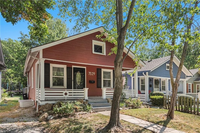 bungalow with fence and covered porch