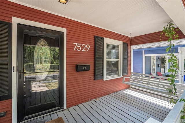 wooden terrace with a porch
