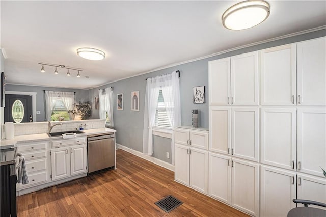 kitchen featuring a sink, visible vents, white cabinetry, dishwasher, and wood finished floors