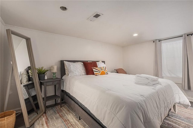 bedroom with crown molding, recessed lighting, and visible vents