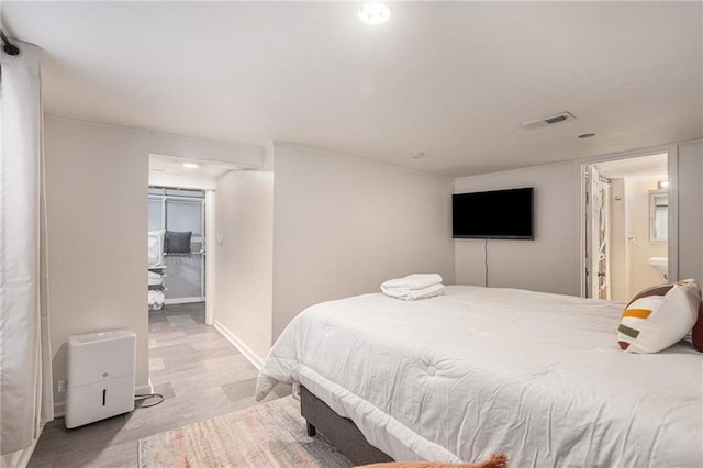 bedroom featuring visible vents and baseboards