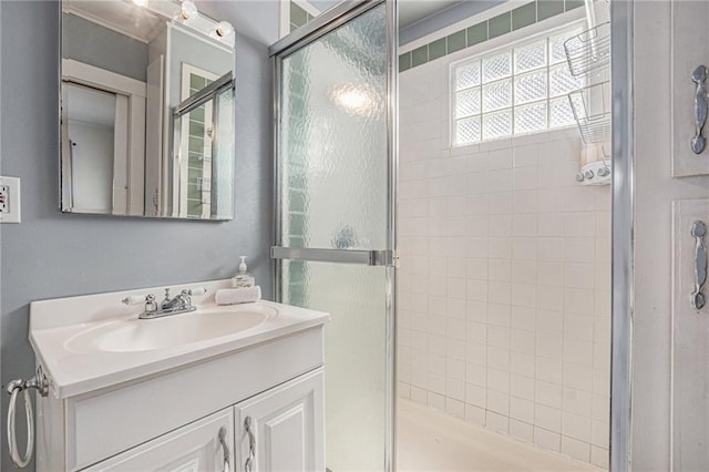 bathroom with a shower stall and vanity