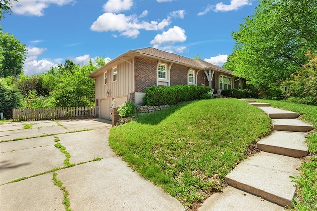 3311 S Crane St, Independence, MO 64055 - ranch-style house featuring an attached garage, driveway, and brick siding