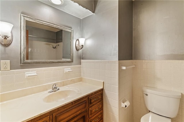 3311 S Crane St, Independence, MO 64055 - bathroom with tile walls, vanity, toilet, and a wainscoted wall