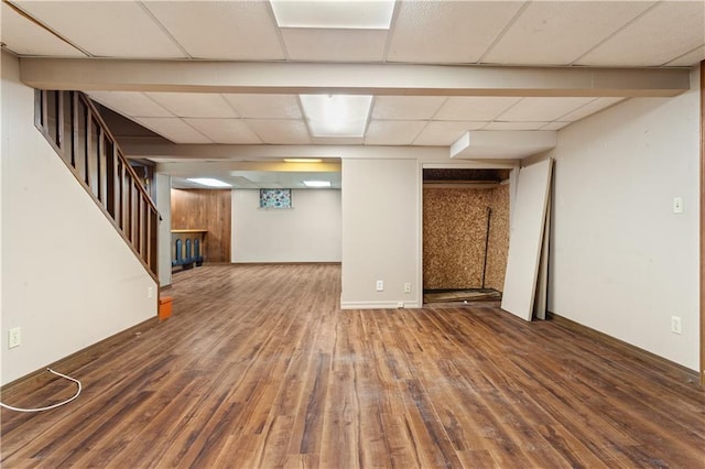 3311 S Crane St, Independence, MO 64055 - finished basement with wood finished floors, stairs, and a drop ceiling