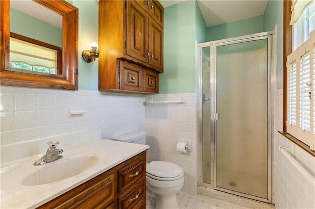 3311 S Crane St, Independence, MO 64055 - full bath featuring tile walls, toilet, a shower stall, vanity, and a wainscoted wall