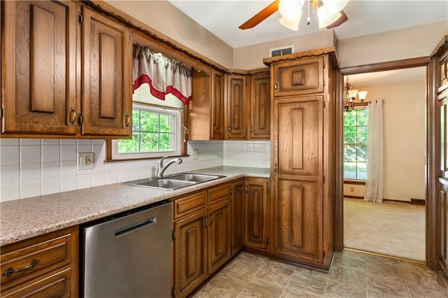 3311 S Crane St, Independence, MO 64055 - kitchen featuring dishwasher, a sink, brown cabinetry, ceiling fan, and light countertops