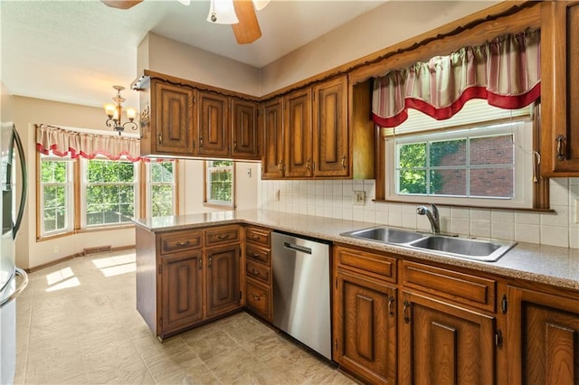3311 S Crane St, Independence, MO 64055 - kitchen featuring dishwasher, a sink, brown cabinets, ceiling fan, and tasteful backsplash