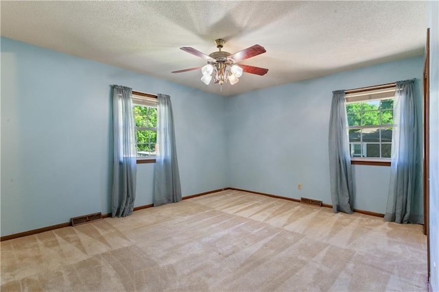 3311 S Crane St, Independence, MO 64055 - unfurnished room with light colored carpet, ceiling fan, a textured ceiling, and baseboards