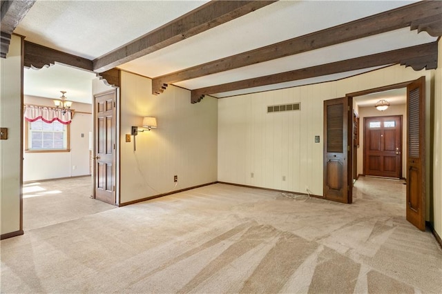 3311 S Crane St, Independence, MO 64055 - unfurnished room with light colored carpet, a chandelier, baseboards, and beamed ceiling