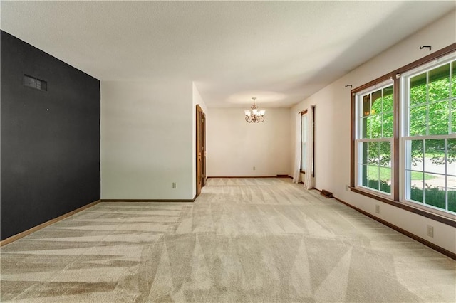 3311 S Crane St, Independence, MO 64055 - unfurnished room with a chandelier, light colored carpet, and plenty of natural light