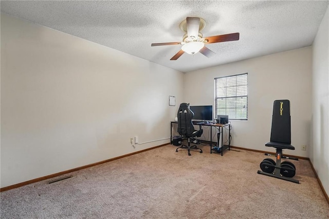office area featuring carpet, a ceiling fan, a textured ceiling, and baseboards