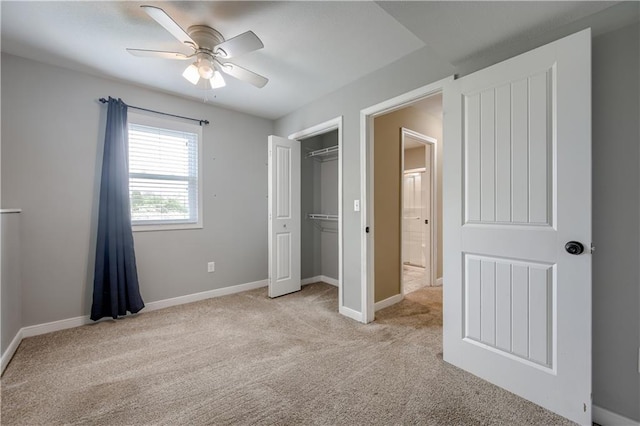unfurnished bedroom featuring baseboards, ceiling fan, a closet, and light colored carpet