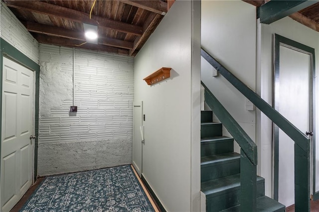staircase featuring wood ceiling and beam ceiling