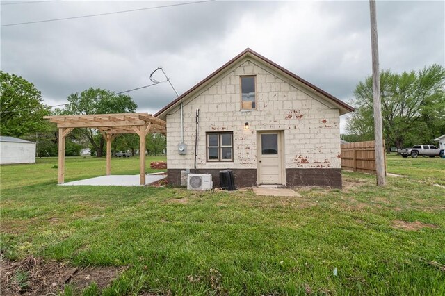 rear view of house with fence, a patio area, ac unit, a pergola, and a lawn