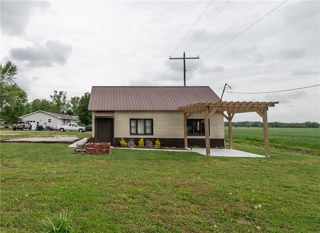 rear view of house with a lawn, metal roof, and a pergola