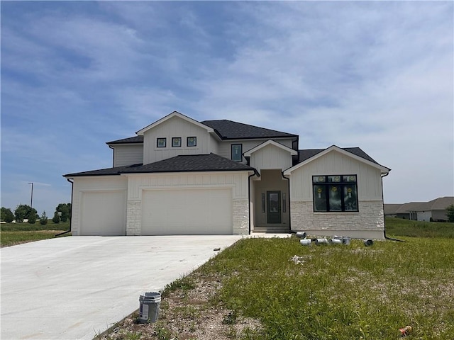 2003 Foxtail Pt, Kearney, MO 64060 - modern farmhouse style home featuring a garage, driveway, a front lawn, board and batten siding, and a shingled roof
