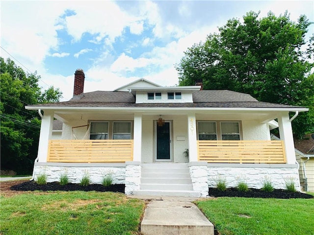 bungalow with a chimney, stucco siding, covered porch, stone siding, and a front lawn