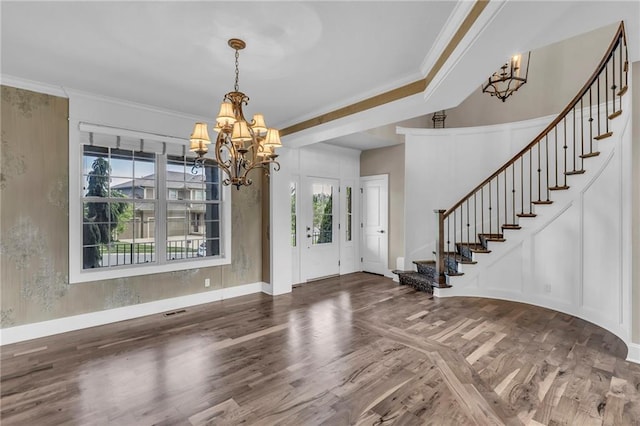 25203 W 97th Ter, Lenexa, KS 66227 - foyer entrance featuring a chandelier, wood finished floors, stairway, baseboards, and ornamental molding