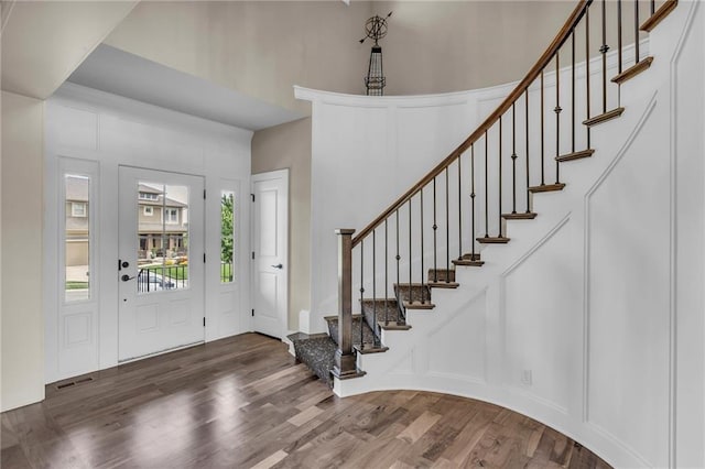25203 W 97th Ter, Lenexa, KS 66227 - foyer entrance featuring wood finished floors, a towering ceiling, and stairs
