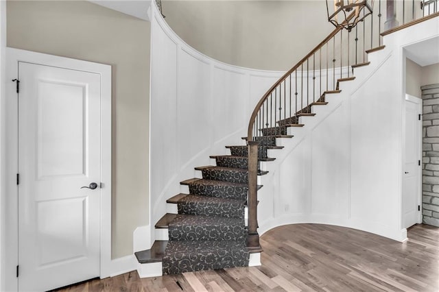 25203 W 97th Ter, Lenexa, KS 66227 - stairs with wood finished floors and a decorative wall