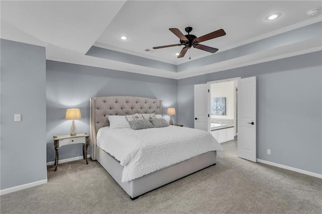25203 W 97th Ter, Lenexa, KS 66227 - carpeted bedroom featuring baseboards, recessed lighting, ornamental molding, a tray ceiling, and ensuite bathroom