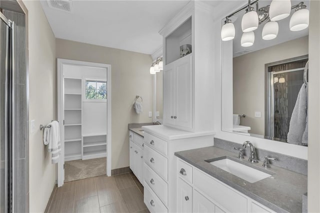 25203 W 97th Ter, Lenexa, KS 66227 - bathroom with a stall shower, vanity, baseboards, and a spacious closet